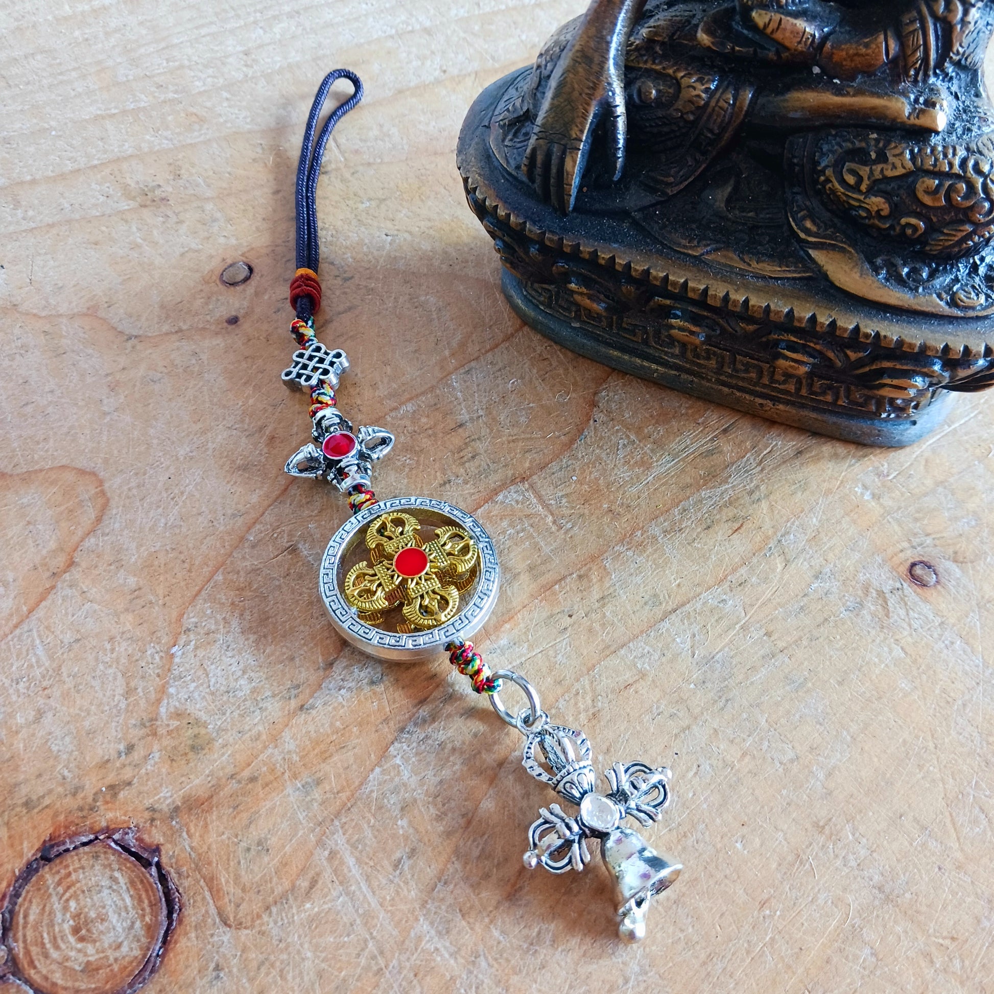 Bring peace, protection, and wisdom wherever you go with this handcrafted Buddhist protective pendant. Featuring the powerful Double Dorje, a symbol of stability and fearlessness, and the Bell, representing wisdom and the understanding of emptiness, this sacred charm is ideal for your car, home, bag, or key ring. Whether you're seeking spiritual grounding or a meaningful gift, this pendant serves as a constant reminder of balance and enlightenment in daily life.