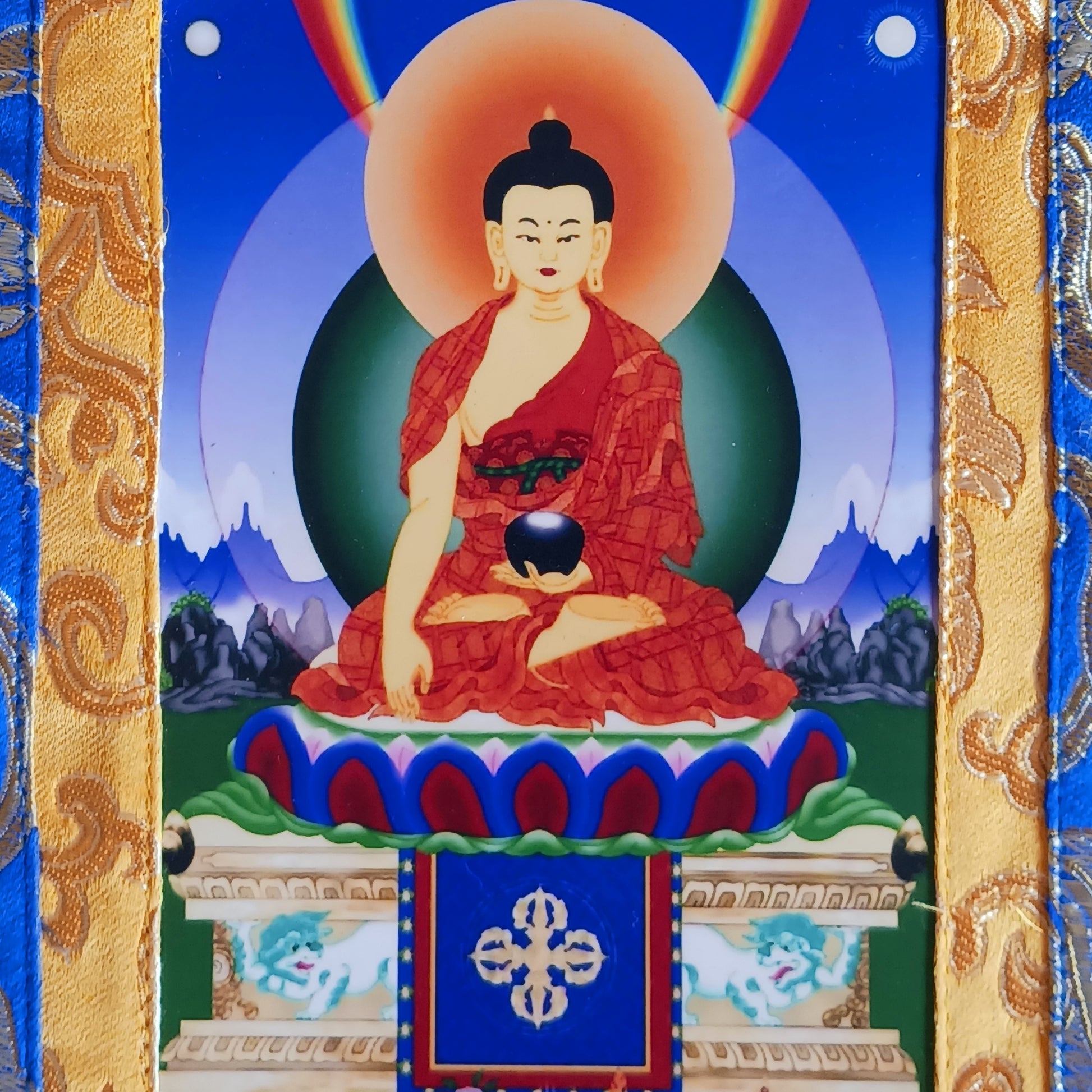 Beautiful small thangka of Shakyamuni Buddha with brocade border. A perfect spiritual art piece for meditation or home altar decoration.