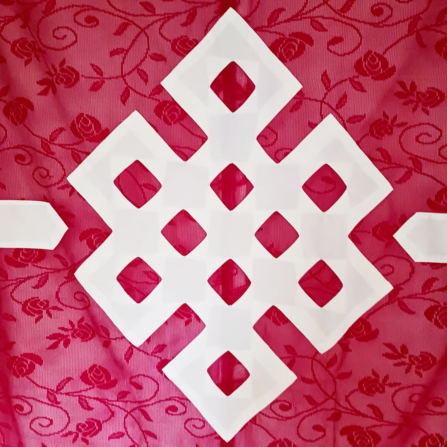 Bring spiritual harmony and traditional Himalayan craftsmanship into your home with this handmade Tibetan Buddhist Endless Knot Door Curtain. Crafted in a rich maroon fabric, this semi-transparent curtain allows natural light to pass through, creating a warm and calming atmosphere.
