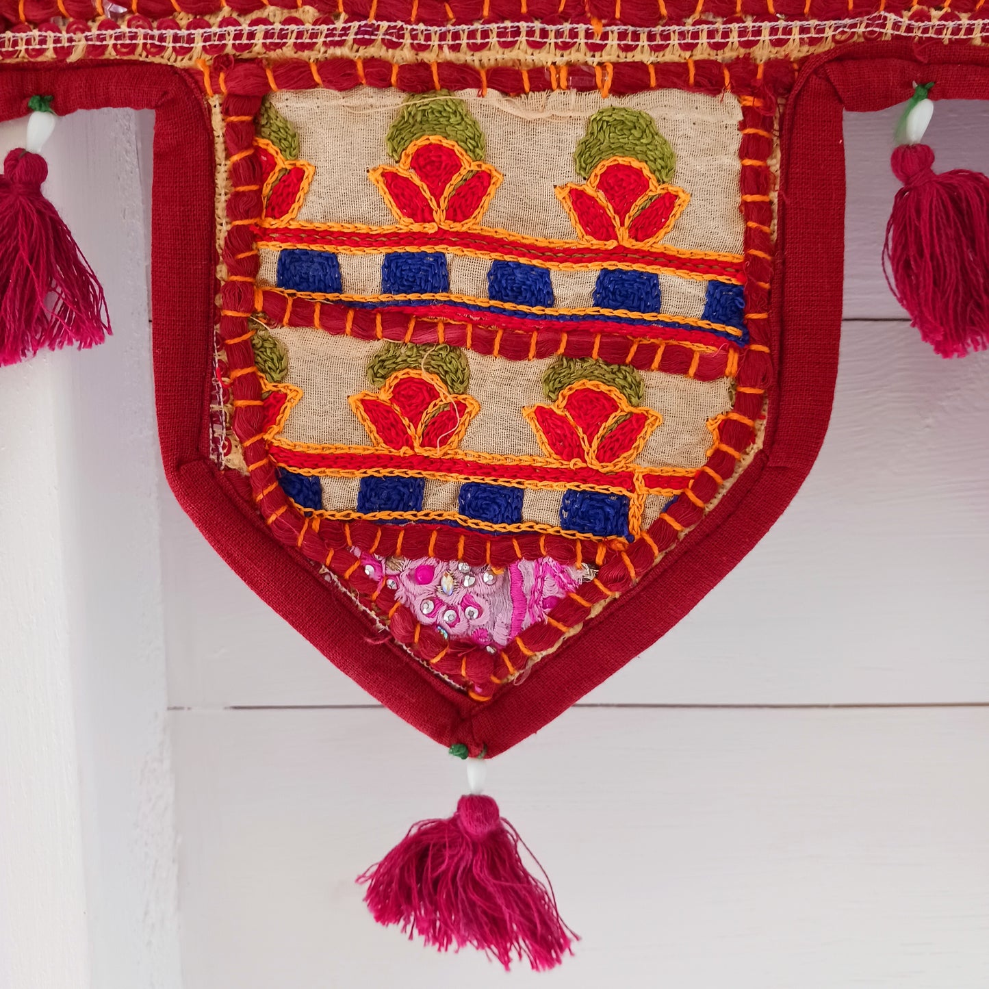 This long and beautifully intricate Indian Toran has been handmade from patches of vintage fabrics, wedding saris and recycled fabrics.  It will be a unique addition to any home and bring vibrancy of colour and embellishment.