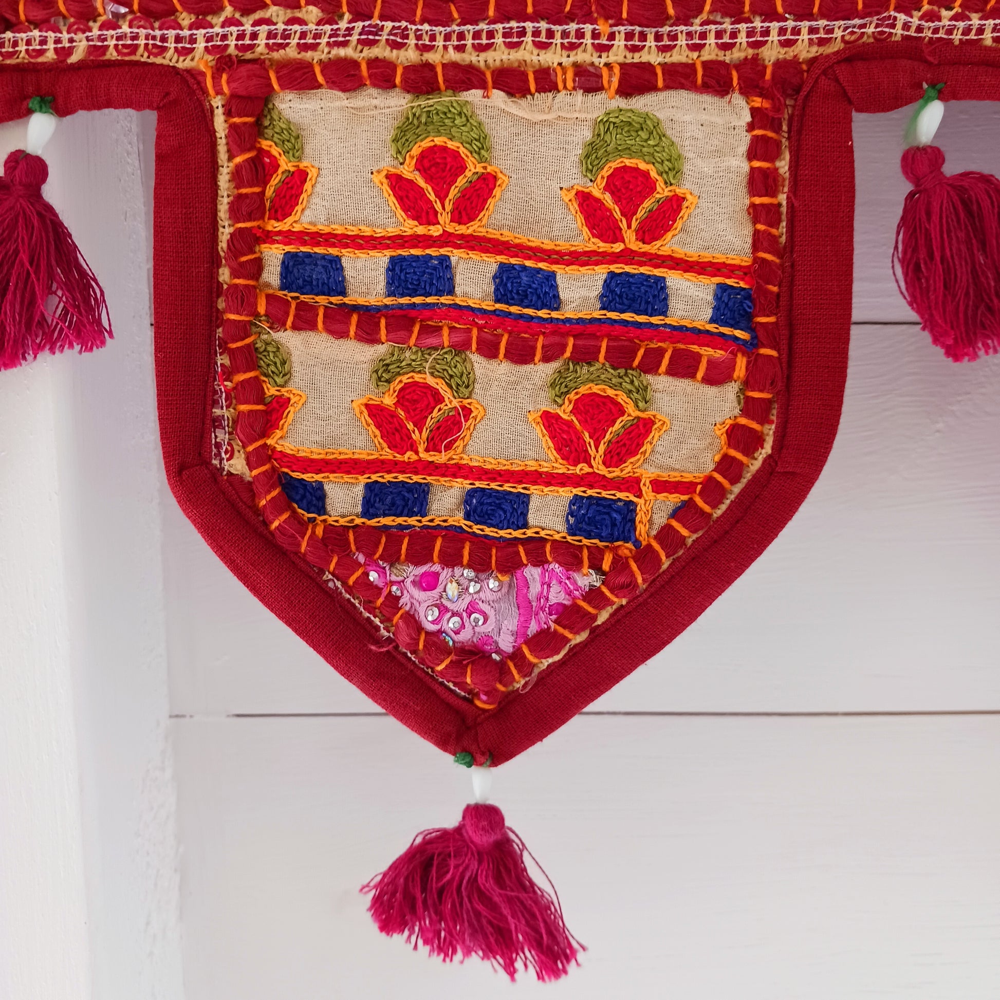 This long and beautifully intricate Indian Toran has been handmade from patches of vintage fabrics, wedding saris and recycled fabrics.  It will be a unique addition to any home and bring vibrancy of colour and embellishment.