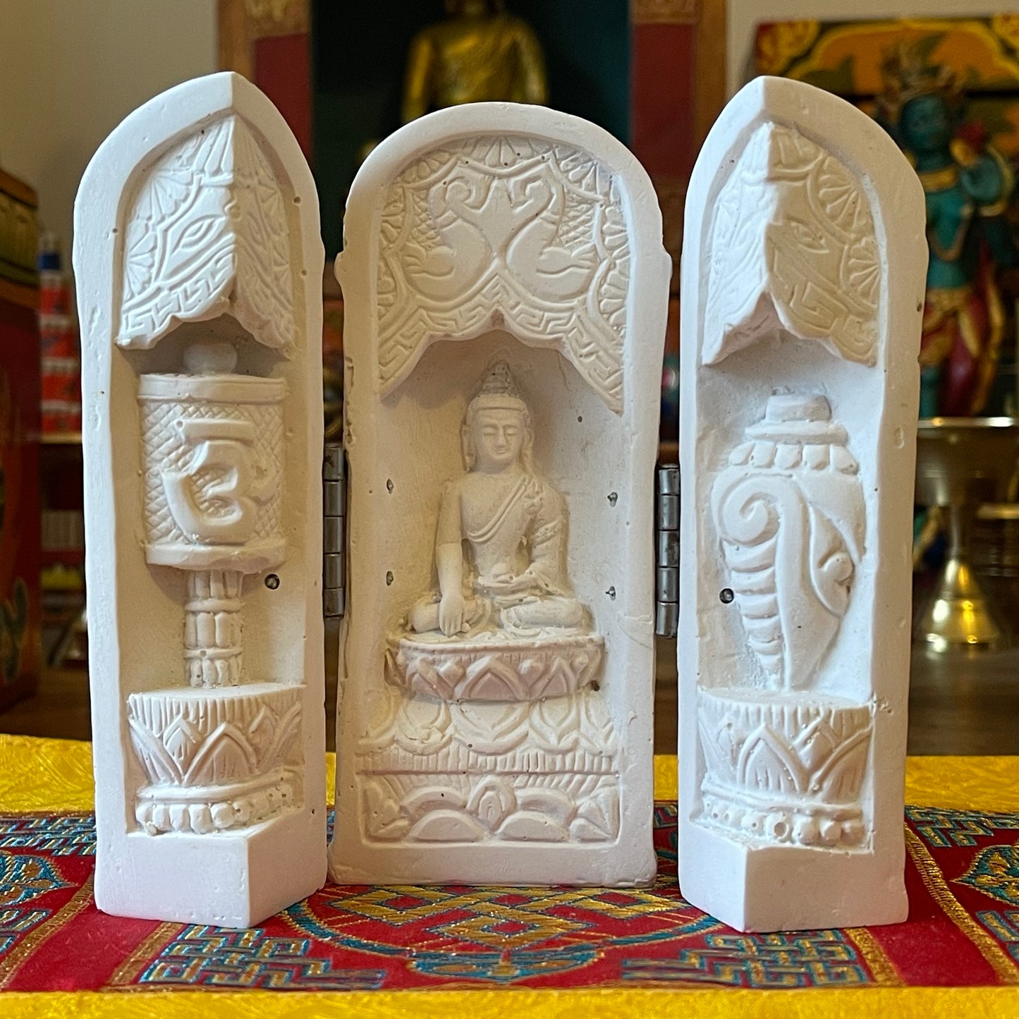 Small Buddha in triptych